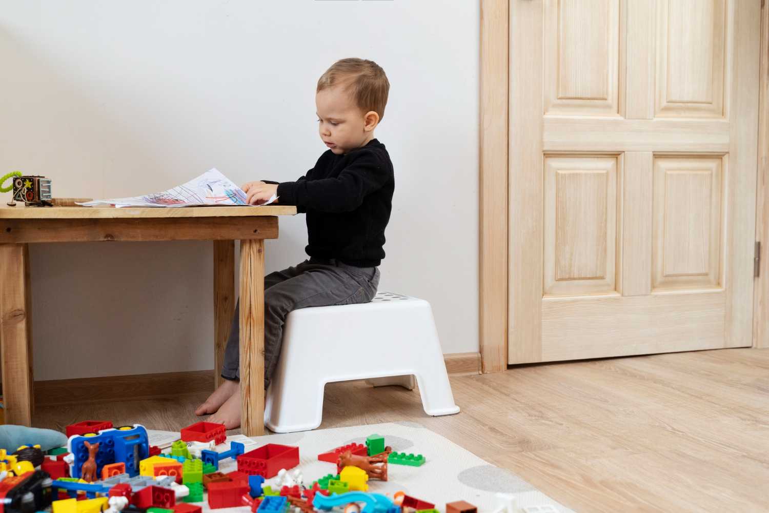 full-shot-cute-kid-drawing-table.jpg